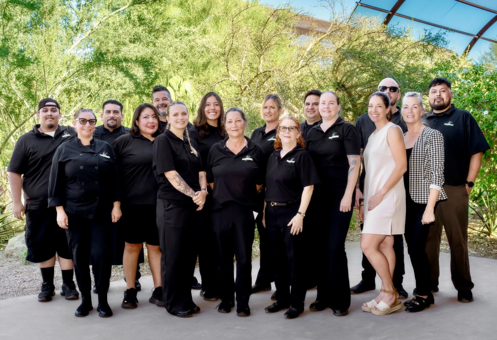 The Fabulous Food team in a corporate group portrait outdoors among green desert landscaping